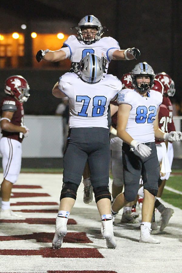 Senior Ben Bodne celebrates with junior Joseph Rampey after a touchdown. Bodne was the driving force in the 28-0 win over Northgate, totaling 140 yards on 21 carries and three touchdowns.