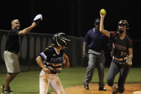 Junior Lauren Flanders runs between third base and home plate to avoid an out. In the three-game series, Flanders went 7-for-13, scoring three runs and stealing five bases. In the end, however, it was Whitewater hoisting the region trophy for the second year in a row after winning the series 2-1.