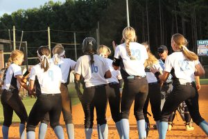 Softball team crowds at home plate to celebrate a home run by sophomore Sarah Latham. Starr’s Mill hit three home runs during the series. The team had to come from behind in both games to sweep the Yellowjackets 10-7 and 10-5.