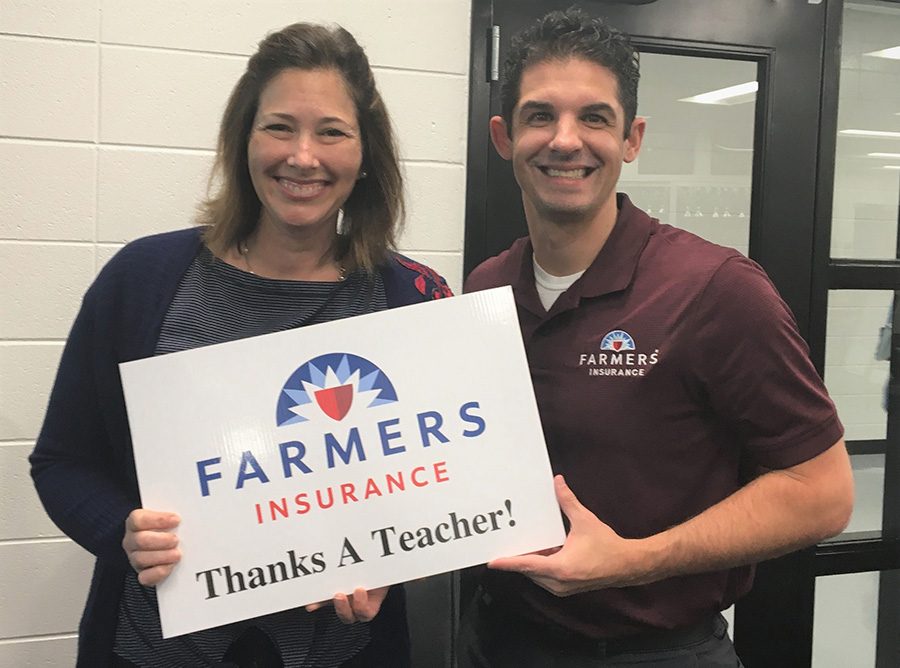 This month’s Golden Apple winner Hope Via stands with Tim Monihan from Farmers Insurance. Via. Via teaches early childcare classes at the Mill.  