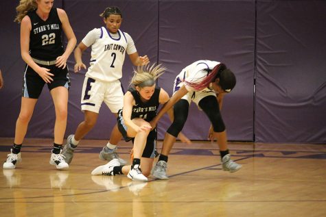 Senior Kara Dial fights with another East Coweta player for possession. Starr’s Mill’s Lady Panther basketball team made too many mistakes that led to a 47-38 loss against the East Coweta Indians.