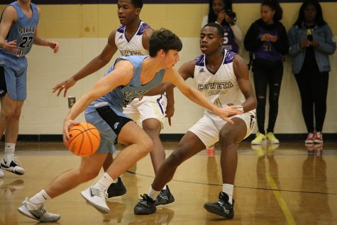 Senior Reese Clevenger maneuvers across the court. Clevenger led the team with 17 points and four three-point field goals.