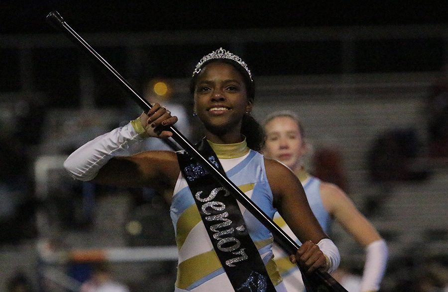 Senior Corinne Knight performs during halftime. This was the last regular season halftime performance for the color guard and band.