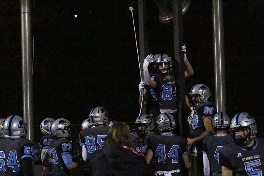 Senior Jack Barczak rings the victory bell and holds up a four on his hand. The Panthers have now won their fourth-straight region championship, tying them with Sandy Creek for the most overall region championships in Fayette County history.