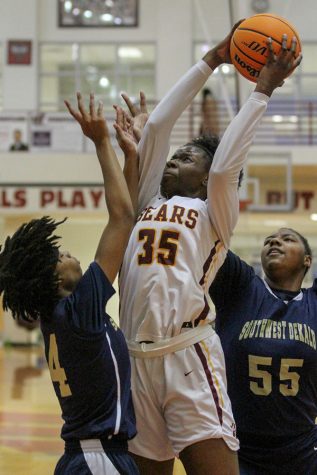 Holy Innocents junior Jillian Hollingshead jumps for a layup between two Southwest Dekalb defenders during the fourth game of the Queens of the Hardwood Classic. Twelve teams met at Whitewater High School and faced off in a series of six matchups. The teams that came out of the event victorious were Elite Scholars Academy, Spalding, Columbus Carver, Holy Innocents, Memphis Arlington, and Westlake. Holy Innocents won their game over Southwest Dekalb 66-47.