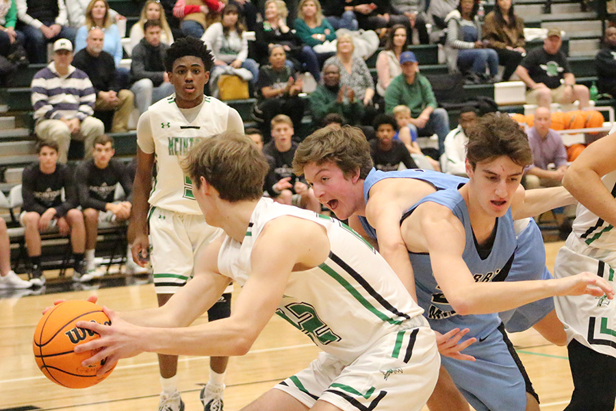 Junior Gabe Sands trips over senior Sam Handel on his way to the ball. Handel scored two points in the game. “Hopefully we’ll see those mistakes that we made on film, and then we’ll come back and do better on those the next time,” head coach Josh Reeves said.