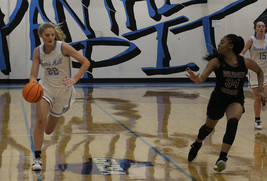 Sophomore Jaclyn Hester drives toward the basket. With 16 points, Hester had one of her best games of the season against the Demons. The Lady Panthers continue their quest for a state championship when they host the Arabia Mountain Lady Rams on Feb. 19.