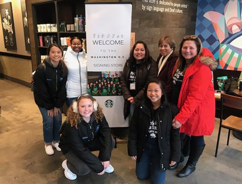 Deaf and Hard of Hearing Academic Bowl team members and chaperones stand next to Starbucks sign near Gallaudet campus. The team competed in the regional tournament, but were eliminated in the round of 16.