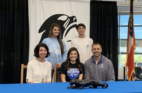 Walker family poses for a picture while Raney signs with University of North Georgia where she will run cross country. From a grandfather who played in the CFL, to a sibling who played in the Little League World Series, the Walker Family has seen its fair share of sports involvement.