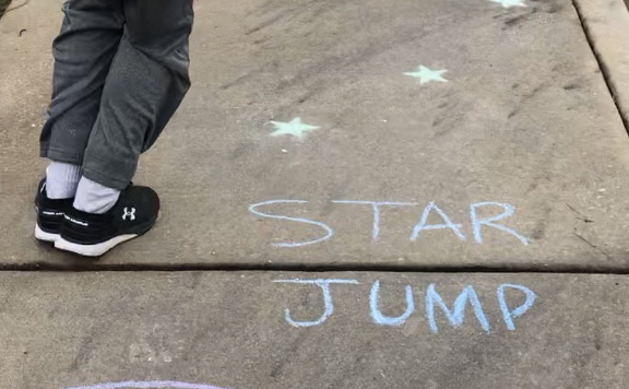 Angie Bryant’s son participates in a chalk exercise for her workout video. Bryant sets up a routine and tries to have at least two days a week scheduled for physical activity. Bryant's videos are just one example of how local community members are helping others during the coronavirus pandemic.