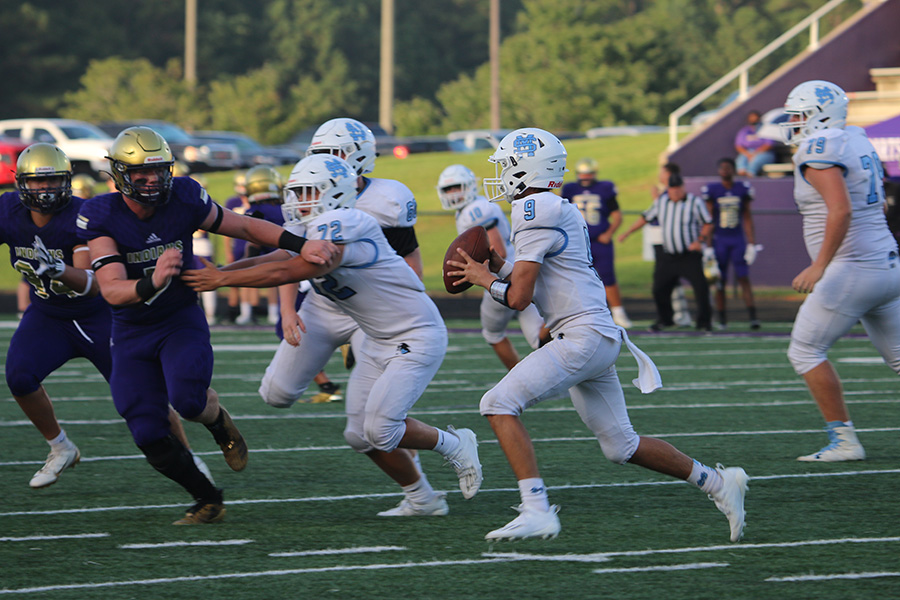 Sophomore Will Yarbrough scans the field for an open receiver during the Panthers’ game against the East Coweta Indians in Sharpsburg last Thursday. A brand new Panther offense rose up, showing tons of promise in a tight contest that ended in a 21-20 victory for East Coweta. Yarbrough made his first start as the team’s quarterback count with six pass completions for 127 yards and two touchdown passes as well as 11 carries for 25 yards. On the contrary, he still showed signs of inexperience with two lost fumbles in the second half.