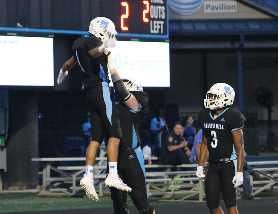 Senior running back Devin Barnett celebrates a touchdown with senior tackle Joseph Rampey and junior running back Brandon Mathis during their home game against the Mt. Zion Bulldogs. A blend between a bend, don’t break defense and a rapid-fire offensive attack led the Panthers to a 35-0 shutout and their first win of the season. Barnett took the ball in five carries for 134 yards and three touchdowns. The Panther offense as a whole put together 294 yards of offense in only about 17 and a half minutes of possession time.