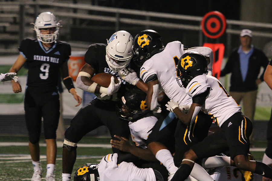 Sophomore running back Greigh Joseph fights through a Harris County defender during the Panthers’ first region game against the Harris County Tigers. In a momentum-deciding game, Starr’s Mill edged out Harris County 14-10 to start region play 1-0. Joseph had his first breakout game of the year with 13 carries for 60 yards and two touchdowns. Eight different rushers carried the ball for the Panthers, combining for 50 rushes that racked up 211 yards, one lost fumble, and 25:39 of game time.