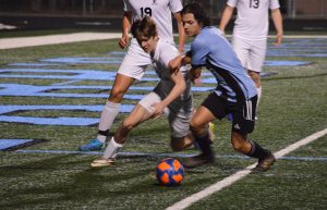 Sophomore midfielder and forward Camilo Velez (11) battles St. Pius defender Max Chartier (21) for the ball. In the second half, Velez assisted forward Brooklyn Muccillo’s goal, putting Starr’s Mill up 3-1. 