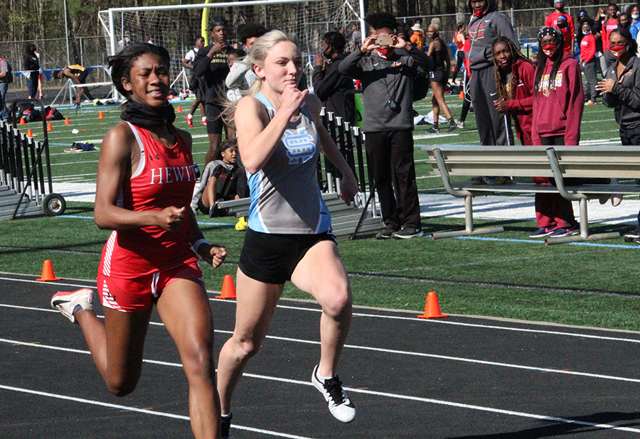 Junior sprinter Sydney Blair keeps up with a runner from Hewitt-Trussville High School in Alabama during the annual Friday Night Lights meet. 18 boys teams and 21 girls teams gathered at Panther Stadium last Friday. Both boys and girls teams overall placed outside the top six. “It was great competition tonight,” track head coach Chad Walker said. “It was a lot of fun, a little bit chilly, but we’re going to build on this.”