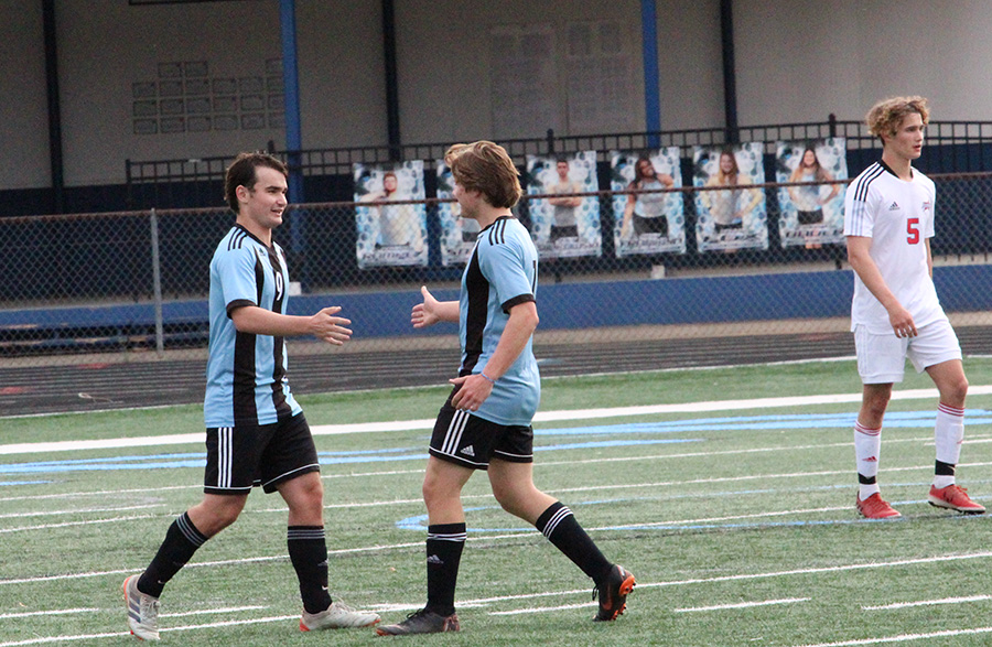 Senior defender Connor Marke (7) congratulates senior captain Brookly Muccillo (9) after a goal. Muccillo had two goals and two assists in the team’s 10-0 win against Northside Columbus. The varsity girls defeated the Patriots 4-1 courtesy of senior Chloe Thompson’s hat trick.