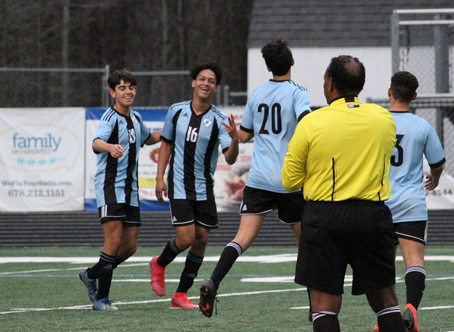 Sophomore midfielder Ali Othman (20) congratulates Leacock (16) after scoring a goal for the Panthers. “Its such a good reward for a guy like Ricardo,” Buck said. “For a guy to come off the bench and score three goals, [his teammates] were as happy for him as he was.”