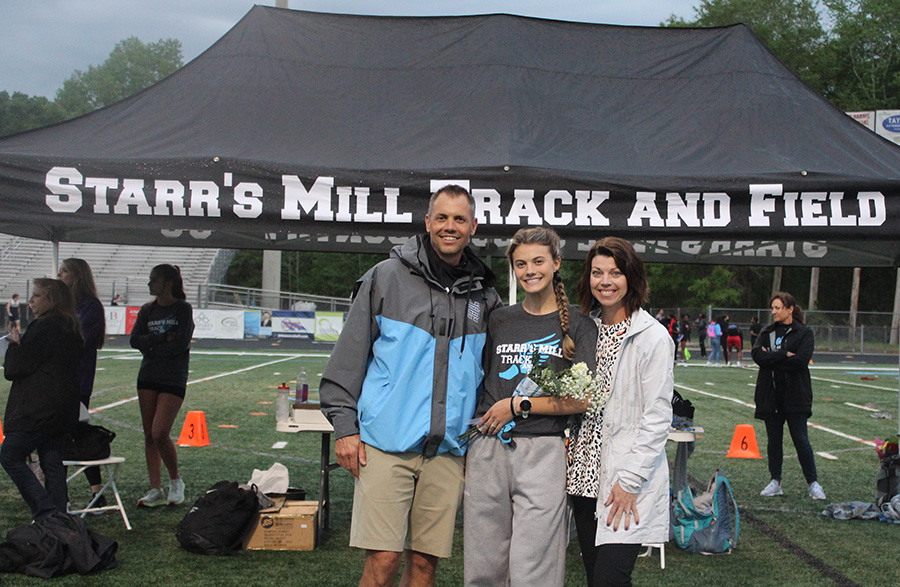 Allie Walker poses with her parents on senior night. She will attend and run for Georgia Tech. “I started running at a young age and I feel in love with it,” Walker said. “It is a stress reliever for me. I just enjoy it and I have met so many good people.”