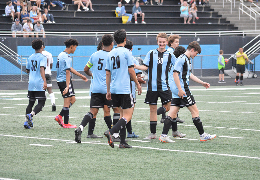 Team members smile as they walk off the field for halftime. The boys varsity soccer team beat Union Grove 6-0 and will play Johnson in the GHSA quarterfinals. 