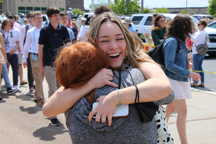 May 20, 2021 - Senior Emily Stackhouse hugs sophomore Andie Whitlock as the seniors say their final goodbye to Starr’s Mill during Senior Walk. 