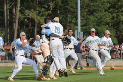 Senior pitcher Daniel Courtney (right) hugs senior catcher Sean White (left) as the rest of the team crowds around them at the end of the AAAAA semifinal series against the Ware County Gators. In a tightly contested series, Starr’s Mill won in game three over the Gators to advance to the state championship for the first time since 2009. They will face the Loganville Red Devils, who are seeking their fourth consecutive state championship title at Truist Park starting next Tuesday at 5 p.m.