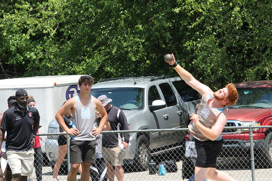 Senior Berry signee Joseph Rampey (right) slings a shot put ball in the shot put finals as sophomore Josh Phifer (left) watches. Three throwers, sophomore Josh Phifer, junior Darrien Doster, and Rampey, threw in shot put for the Panthers. Only Rampey was able to qualify for the state with a distance of 49 feet and 5 inches. Rampey will head to Berry after high school to play football and throw.