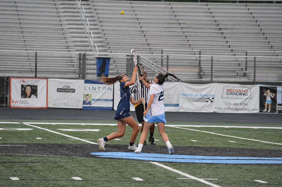Junior Hannah Leon faces off with a Fellowship Christian player in the second round of the GHSA state playoffs. Leon contributed four goals and two draw controls. 