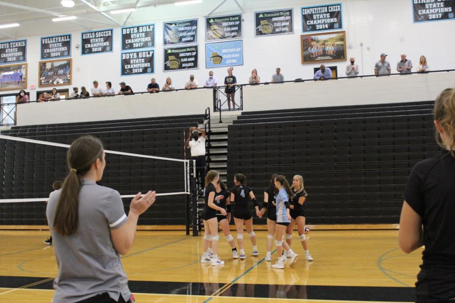 JV volleyball head coach Shayne Thompson looks on as the team celebrates a point against Fayette County. The Lady Panthers cruised to victory over the Lady Tigers 25-6, 25-4, but could not overcome mid-game deficits versus East Coweta losing 25-19, 25-18.