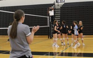 JV volleyball head coach Shayne Thompson looks on as the team celebrates a point against Fayette County. The Lady Panthers cruised to victory over the Lady Tigers 25-6, 25-4, but could not overcome mid-game deficits versus East Coweta losing 25-19, 25-18.