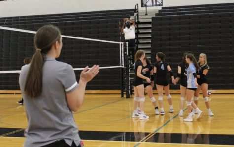 JV volleyball head coach Shayne Thompson looks on as the team celebrates a point against Fayette County. The Lady Panthers cruised to victory over the Lady Tigers 25-6, 25-4, but could not overcome mid-game deficits versus East Coweta losing 25-19, 25-18.