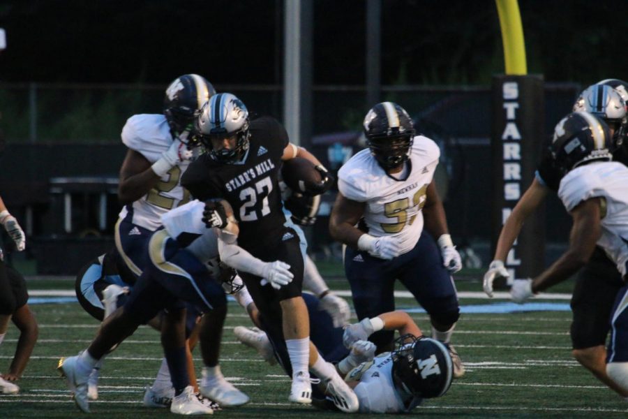 Junior running back Jacob Free attempts to avoid a tackle from the Newnan defense. Free rushed four times for 75 yards and scored in the third quarter on a 53-yard run. Starr’s Mill rushed 44 times for 365 yards in the team’s 28-14 over the Cougars to begin the season.