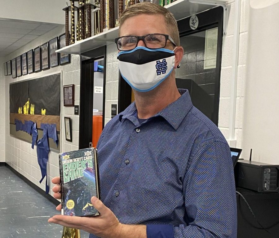Assistant band director Bert Groover holds his favorite book “Ender’s Game.” He enjoys reading about the characters and the storyline that takes place in outer space.