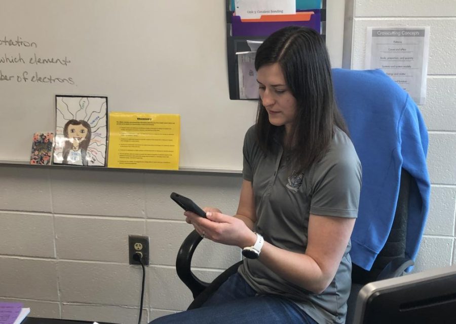 Forensic science teacher Jessica Tatum reads “Cometh the Scythesman,” a book only available online that explores good overcoming evil.