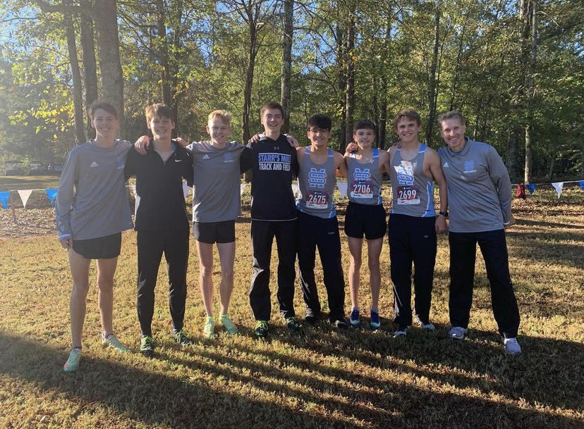 Varsity boys pose before the region championship race at One Church.  The boys finished 1st and the varsity girls placed 4th.