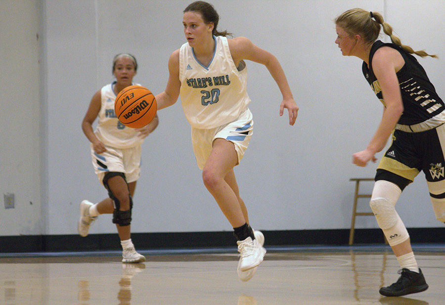 Sophomore Brooke Godown (20) dribbles the ball down the court. “Later on, if we see them next time in the season, I think wed come out with a different attitude,” Godown said.