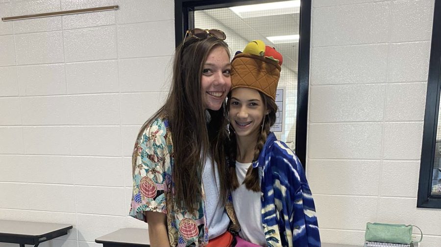 Sophomore Rosie Miller (left) and freshman Emma Arnold (right) pose for a picture in their “Tacky Tourist” outfits. On many dress up days during homecoming week, students break dress code in order to complete their outfits.