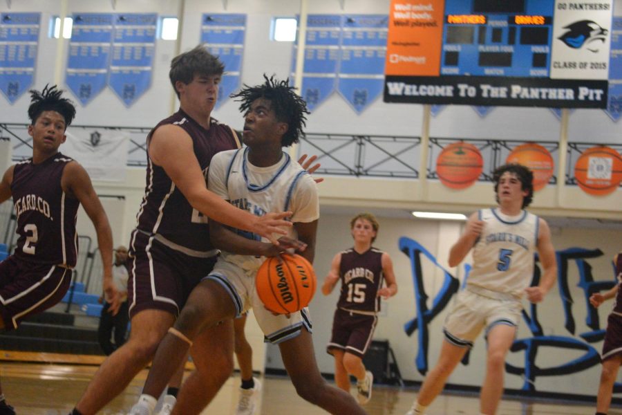 Sophomore Russell Logan drives to the basket against a Heard County defender. Logan was at the forefront of Starr’s Mill offense with 14 points in the win against Heard County. 