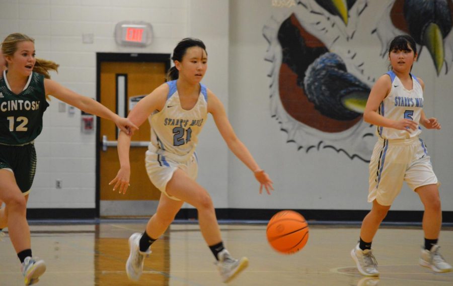 Sophomore Momo Suga avoids a McIntosh defender. Suga led the Lady Panthers in scoring with nine points as Starr’s Mill defeated the Lady Chiefs 32-14.