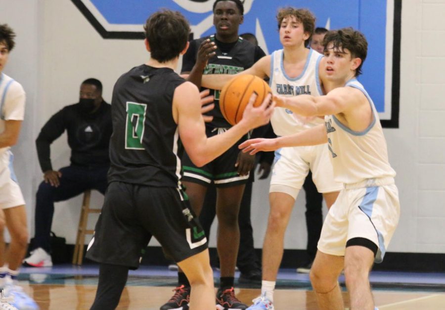 Senior Evan Courville defends junior Brandon Cheri. After a 61-52 loss to McIntosh, the varsity boys basketball team is 1-8 overall and 0-3 in region play heading into the semester break. 