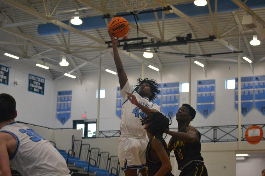 Sophomore Rusell Logan drives for a layup over a Griffin defender. A strong offensive attack contributed greatly to a dominant Panther victory over Griffin, 57-26. 