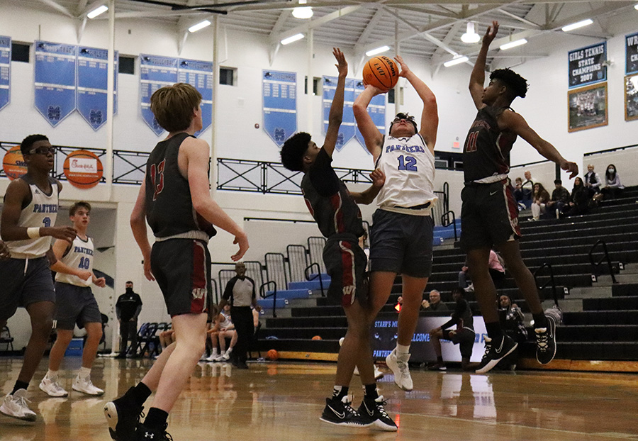 Logan Inagawa attempts a shot against two Whitewater players. Starr’s Mill defeated the Wildcats 31-29 after trailing for three quarters of play.