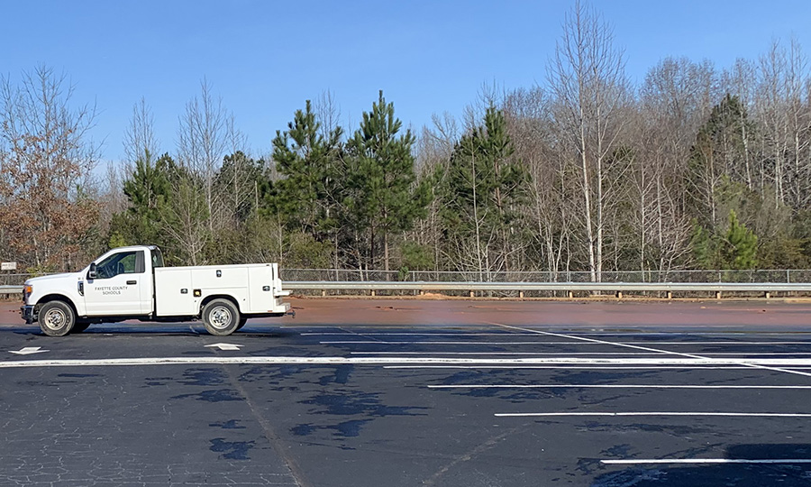 Water floods the far end of the student parking lot at Starr’s Mill. School has been canceled for the entire south complex after a water main broke this morning, flooding the lot and blocking traffic on Panther Path. Fayette County officials are currently working to find the cause of the break, and repair it in time for school to resume tomorrow. 