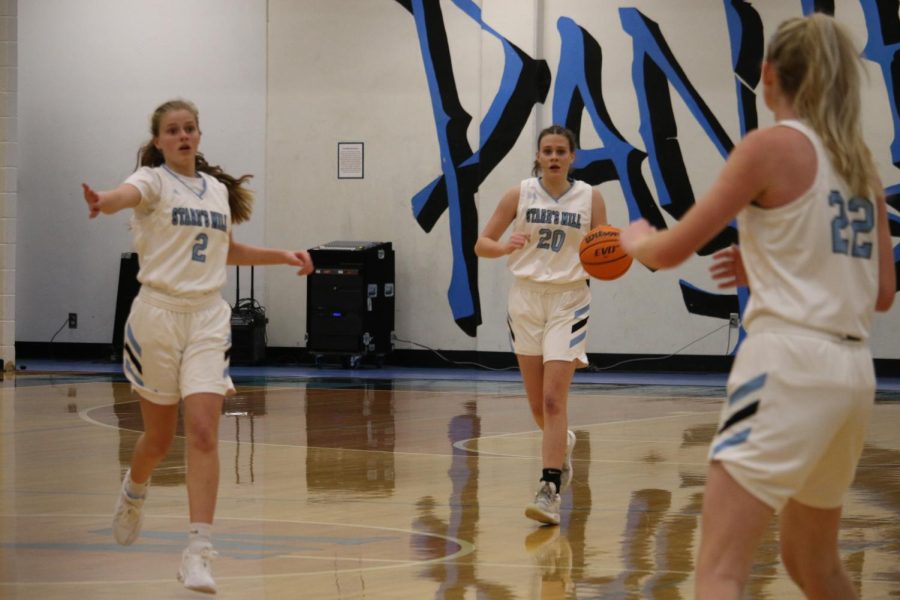 Sophomore Brooke Godown (20) brings the ball up the court with sophomore Brooke Herdman (2) and senior Jacklyn Hester (22) in the foreground. “We were at Destin for semester break so that really boosted our momentum and got us going,” Godown said. “It actually helped us a lot more.”