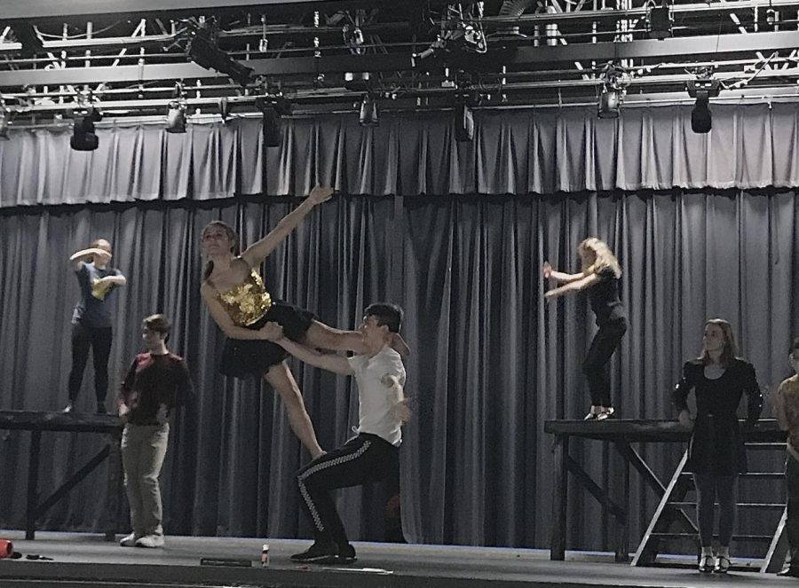 Junior Aleena Soto stands on senior Henry Ravita as part of the drama department’s multiple acrobatic acts. For their annual musical, the drama department has chosen to perform the frame story musical “Pippin,” complete with aerial silk aerobics and other circus acts.