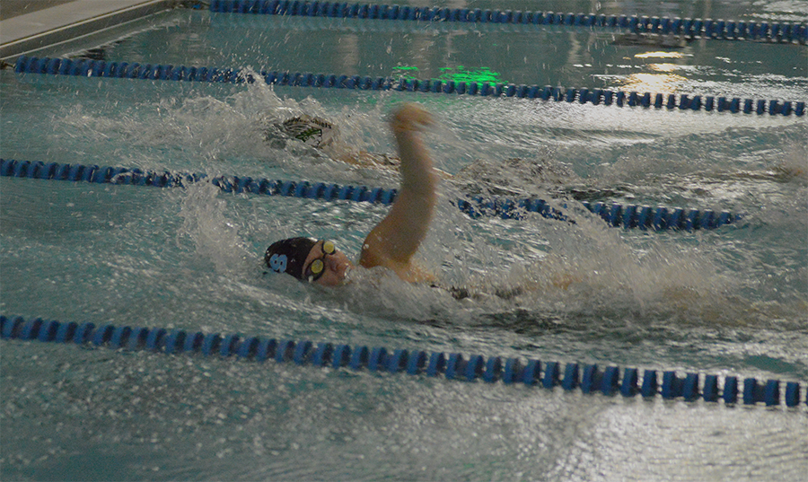 Sophomore Katie Rausch races a McIntosh swimmer in the 4x50-yard medley relay. Rausch swam the backstroke leg of the relay that placed first ahead of McIntosh by .6 seconds.