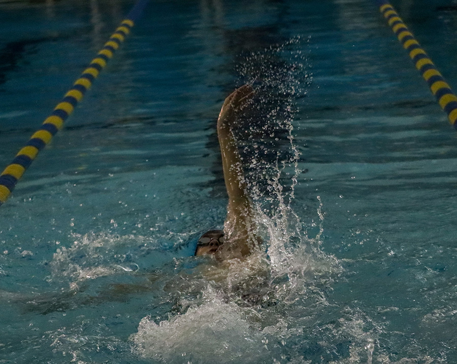 Senior+Peter+Beardsley+races+in+the+100-yard+backstroke+in+the+Country+Championship+last+Friday.+He+placed+7th+with+a+time+of+1%3A15.97.+