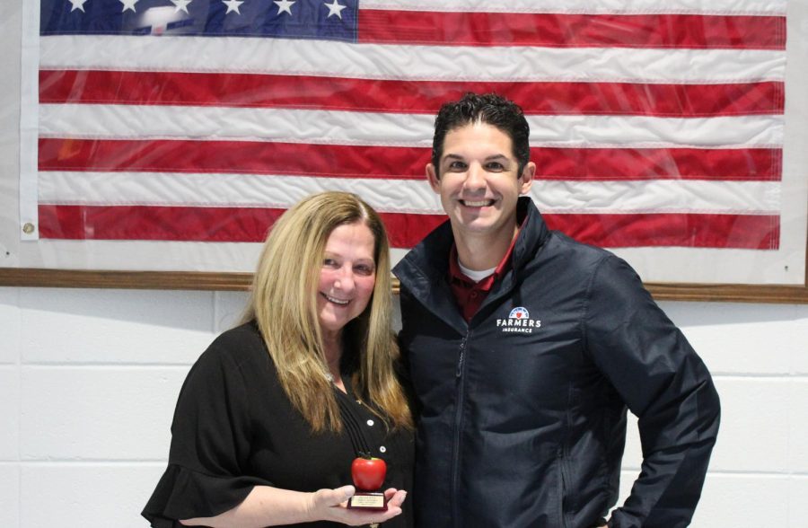 This month’s Golden Apple teacher is Cindy Hartpence pictured with Tim Monihan from Farmers Insurance. Art teacher Todd Little chose Hartpence for her dedication and empathy she shows toward her students.