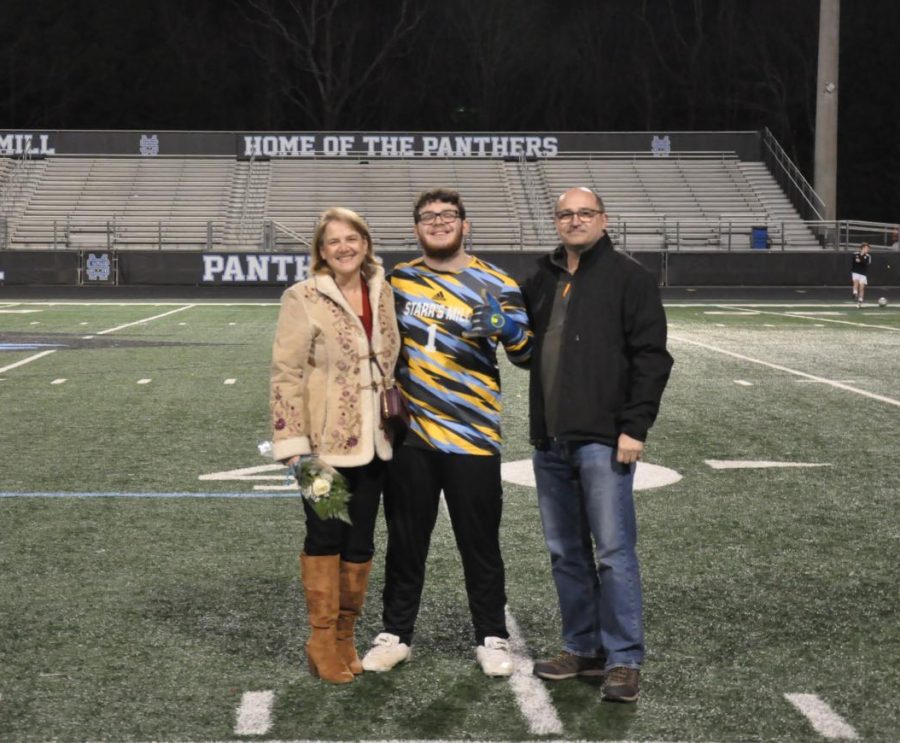 Starr’s Mill goalie Marcelo Quinones-Vilela poses with his parents for senior night prior to the game. Quinones-Vilela was one of nine senior boys recognized.