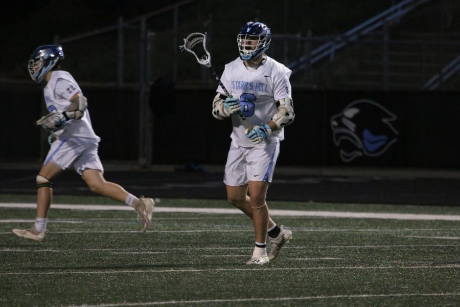 Senior Barrett Schmidlkofer passes the ball, while teammate sophomore Charles Cocrhan runs toward the goal. Trinity entered Thursday’s game 8-2 and the Panthers came in 8-4 with both undefeated in area play. Starr’s Mill capitalized on strong offense and communication, winning 16-1.