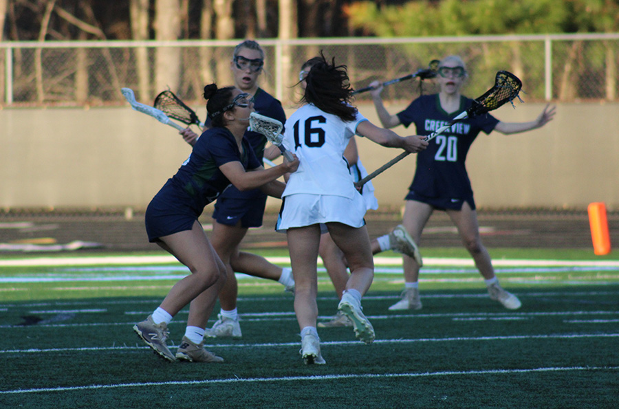 Junior Elise Mercure runs past a Creekview defender. Mercure collected two draw controls and two ground balls in the game.